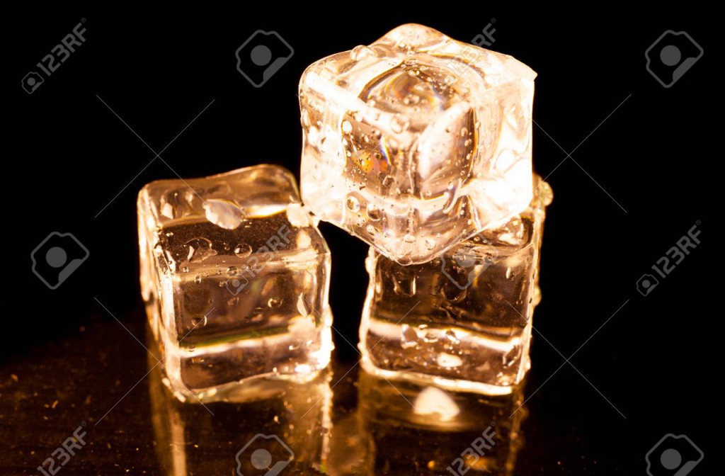 86954088 gold ice cubes on black background